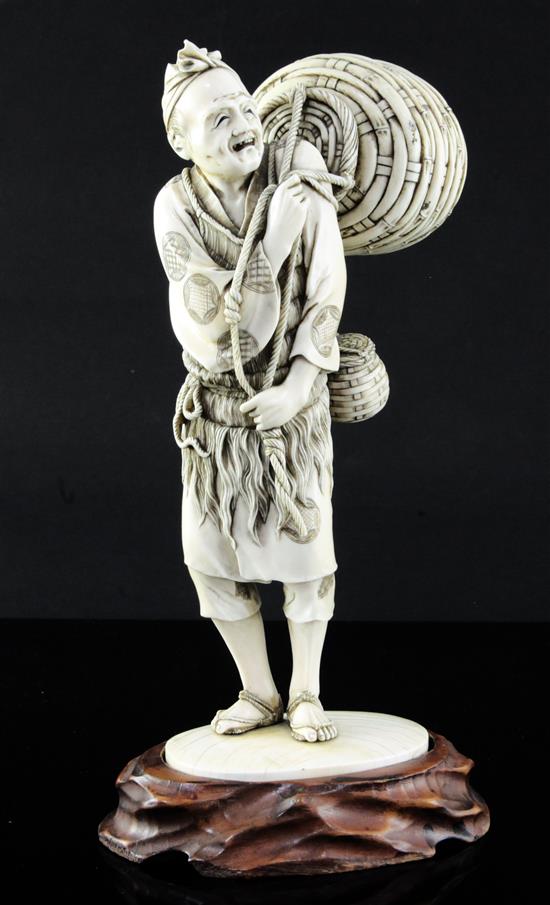 A large Japanese ivory figure of a fisherman, Meiji period, 25.5cm, wood stand